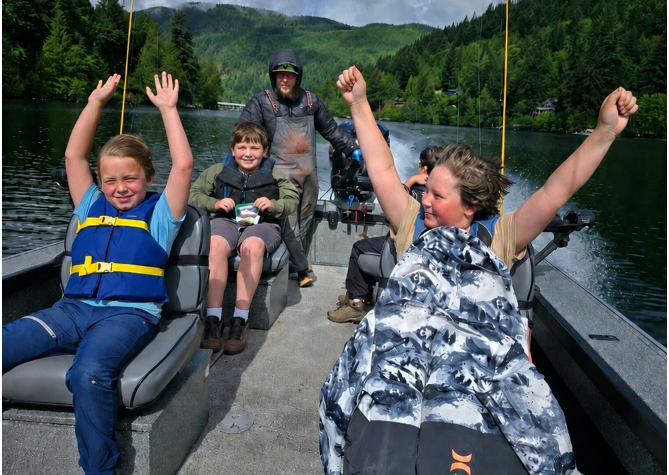 Kids celebrating together during a boat ride at PNW Provides Kids Fishing Day